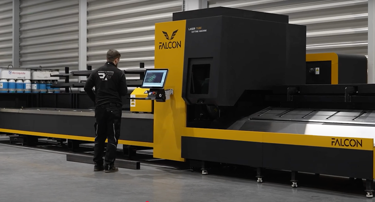 photograph showing employee operating Falcon laser cutting machines